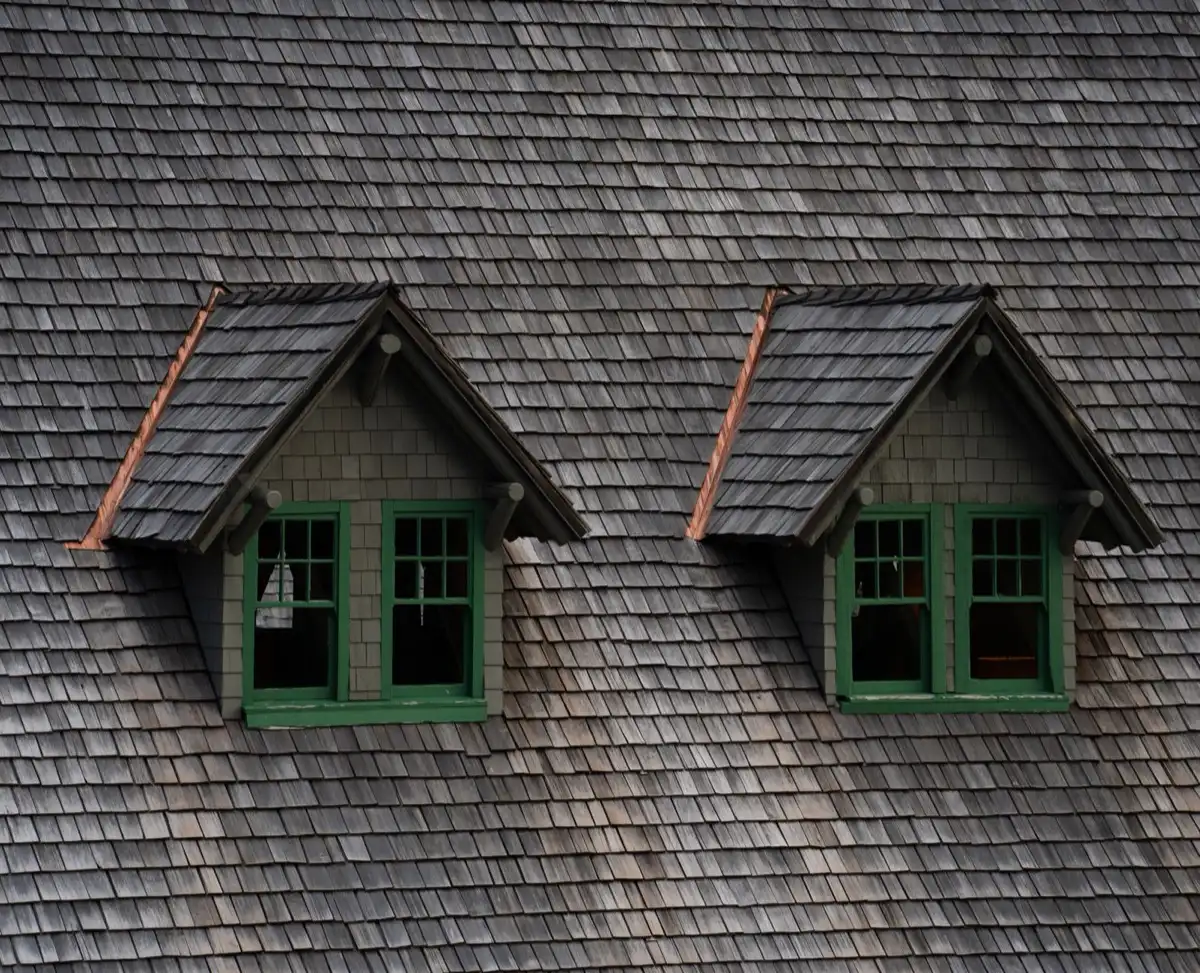 Dormers on a shingle roof in Bend, OR, where step flashing and kickout flashing carry water past the walls